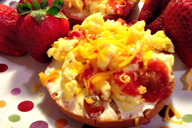 Spread a bagel with cream cheese and top with scrambled eggs, salsa, and cheddar. LOTS of other ideas here too.